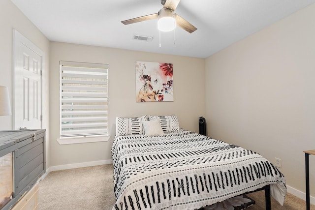 carpeted bedroom featuring a ceiling fan, baseboards, visible vents, and multiple windows
