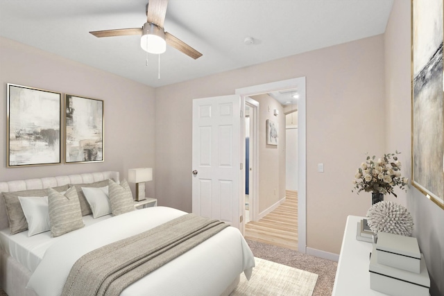 bedroom featuring baseboards, ceiling fan, and light carpet