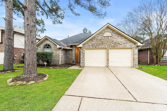 22731 Willhanna Dr, Katy, TX 77449 - view of front facade with a garage, driveway, a front yard, brick siding, and a shingled roof