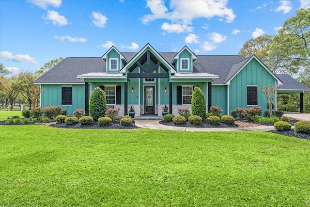 craftsman house featuring board and batten siding, a front lawn, and stone siding