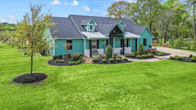 craftsman inspired home featuring covered porch, board and batten siding, concrete driveway, and a front lawn