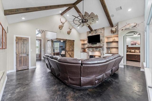 living room with built in features, beamed ceiling, a ceiling fan, and visible vents