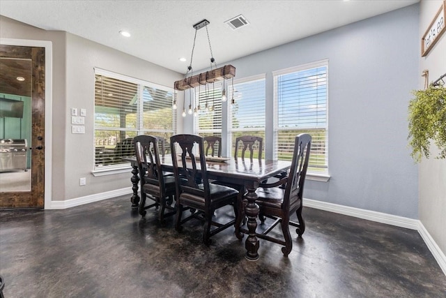 dining space with baseboards, visible vents, plenty of natural light, and finished concrete floors