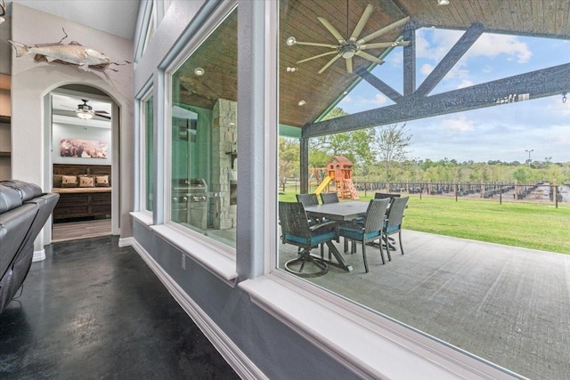 view of patio / terrace with a ceiling fan, a playground, and fence