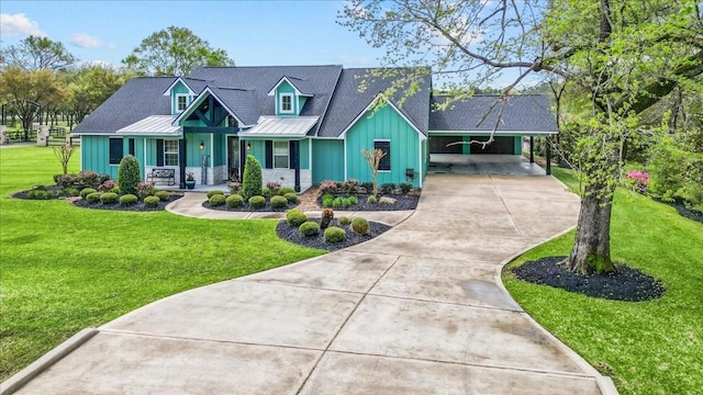 view of front of house with board and batten siding, a carport, a front yard, covered porch, and driveway