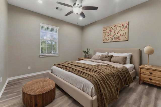 bedroom with visible vents, wood finished floors, baseboards, ceiling fan, and recessed lighting