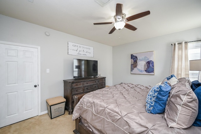 bedroom featuring visible vents, a ceiling fan, and light colored carpet