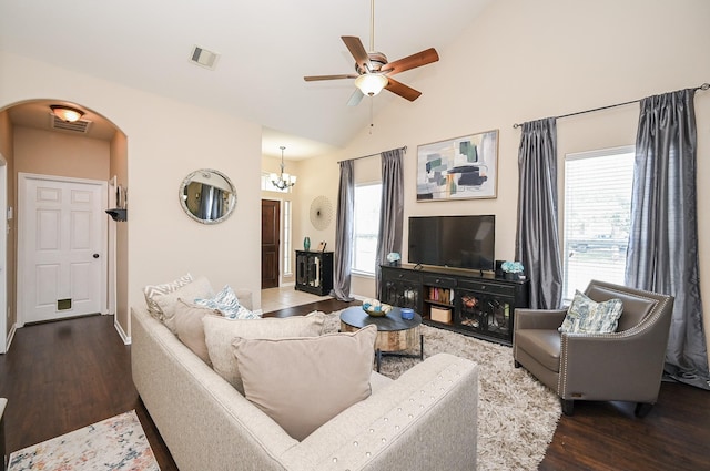 living area with wood finished floors, visible vents, arched walkways, baseboards, and ceiling fan with notable chandelier