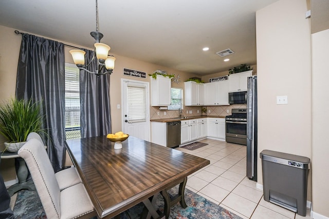 dining space with recessed lighting, visible vents, light tile patterned flooring, baseboards, and a notable chandelier