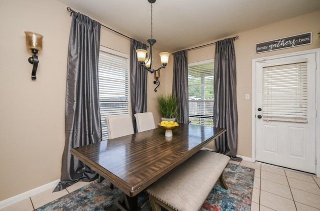 dining room with baseboards, an inviting chandelier, and light tile patterned floors