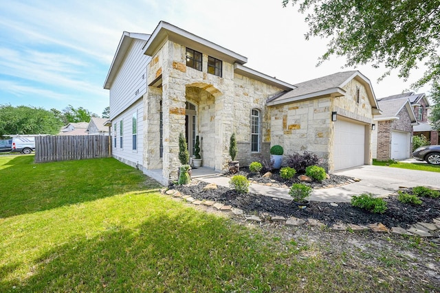 view of front facade with a garage, fence, stone siding, and a front yard