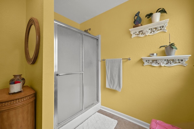 8703 County Road 48, Rosharon, TX 77583 - bathroom featuring a shower stall, baseboards, and tile patterned floors