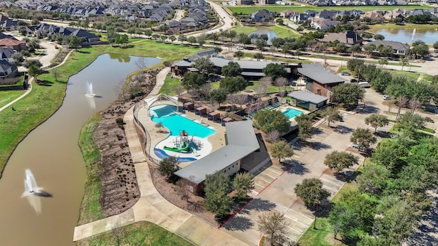 drone / aerial view featuring a water view and a residential view