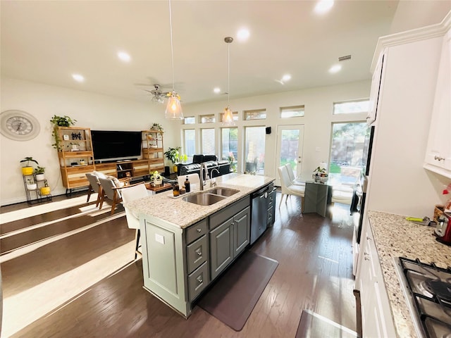 kitchen with open floor plan, gray cabinets, white cabinetry, a sink, and appliances with stainless steel finishes