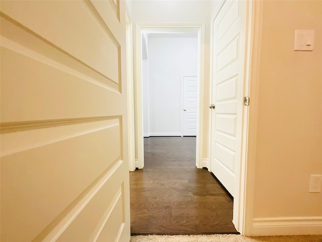 corridor with dark wood-type flooring