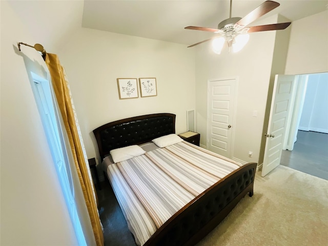 bedroom with carpet flooring, ceiling fan, and vaulted ceiling