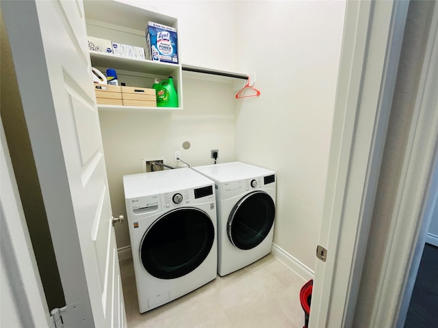 clothes washing area featuring laundry area, washer and clothes dryer, and baseboards