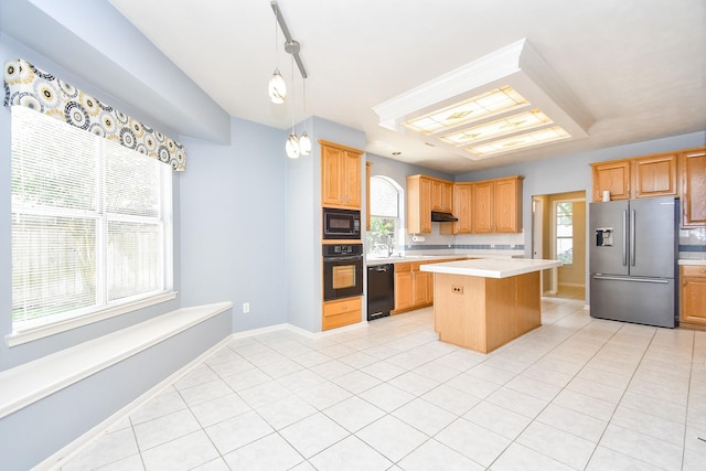 kitchen featuring a center island, plenty of natural light, light countertops, and black appliances