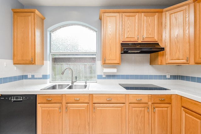 kitchen with tasteful backsplash, a sink, black appliances, light countertops, and under cabinet range hood