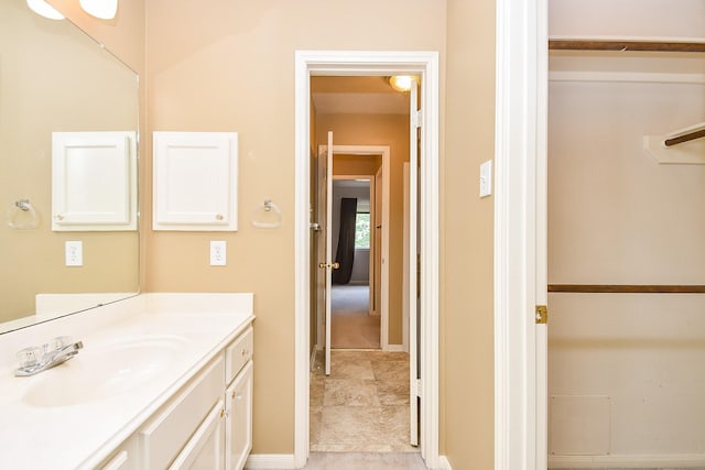 bathroom featuring baseboards and vanity