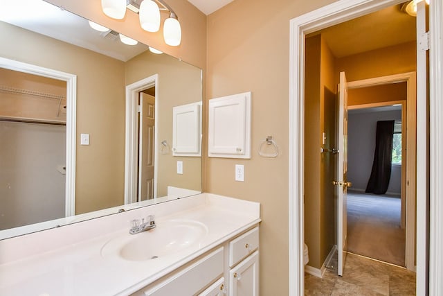 bathroom with visible vents, toilet, and vanity