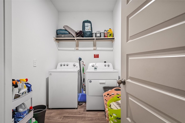 laundry area with independent washer and dryer, laundry area, and wood finished floors