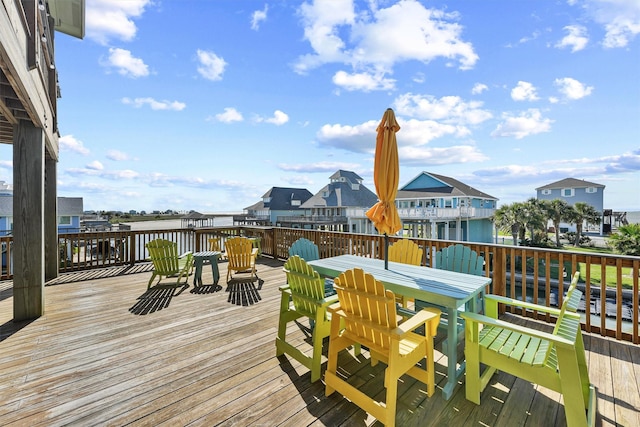 23006 Martes St, Galveston, TX 77554 - wooden terrace featuring outdoor dining space and a residential view
