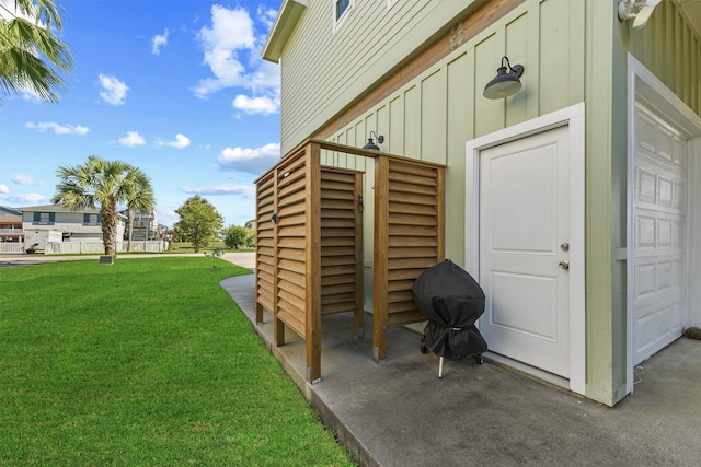 23006 Martes St, Galveston, TX 77554 - view of exterior entry featuring board and batten siding and a lawn