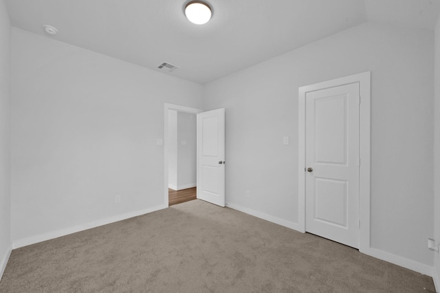 unfurnished bedroom featuring carpet floors, visible vents, and baseboards