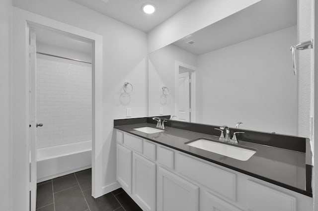 bathroom with baseboards, tile patterned flooring, a sink, and double vanity