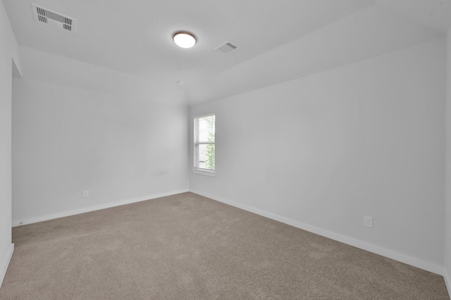 carpeted empty room featuring baseboards and visible vents