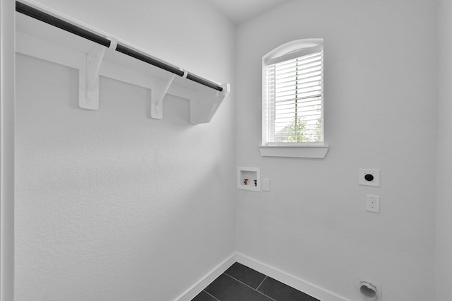 laundry room with hookup for an electric dryer, baseboards, washer hookup, dark tile patterned flooring, and laundry area