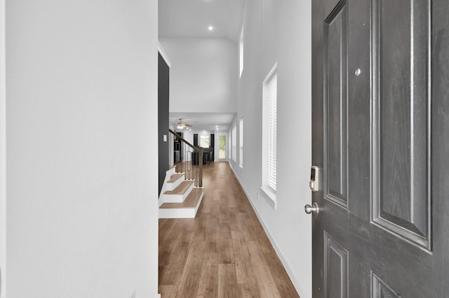 entryway with stairway, wood finished floors, ceiling fan, baseboards, and recessed lighting