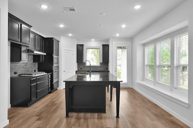 kitchen featuring visible vents, a wealth of natural light, stainless steel appliances, and a sink