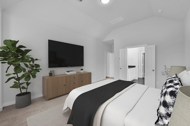 bedroom featuring light carpet and vaulted ceiling