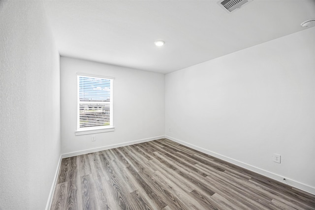 12305 Brandenburg Gate Dr, Houston, TX 77047 - spare room featuring wood finished floors, baseboards, and visible vents