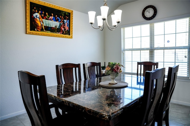 dining area featuring tile patterned flooring, baseboards, and an inviting chandelier