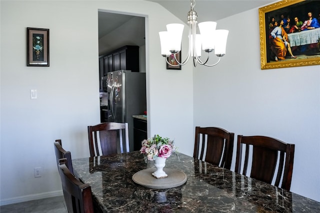 dining area with a chandelier, light tile patterned floors, and baseboards