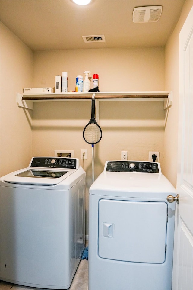 laundry room with separate washer and dryer, laundry area, and visible vents
