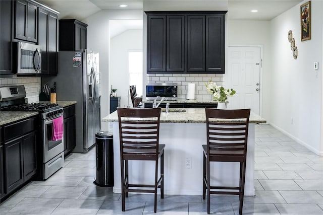 kitchen with tasteful backsplash, a breakfast bar, vaulted ceiling, stainless steel appliances, and light stone counters