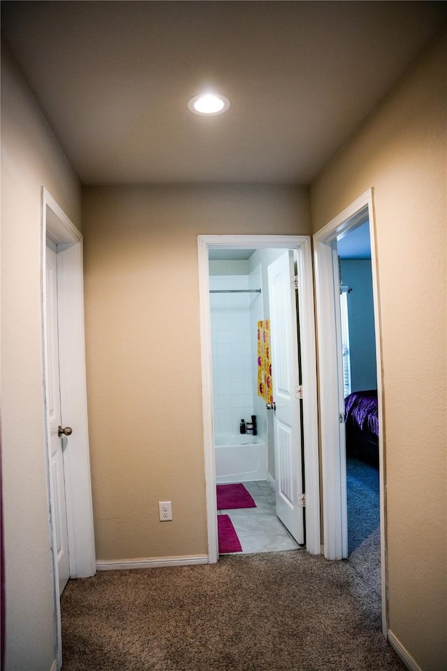 hallway with recessed lighting, baseboards, and carpet floors