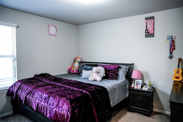 carpeted bedroom featuring baseboards