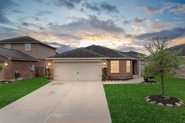 single story home with driveway, a front yard, an attached garage, fence, and brick siding