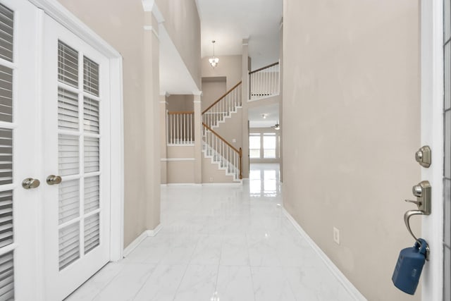 4902 Bellmead Dr, Missouri City, TX 77459 - entryway with marble finish flooring, stairs, baseboards, and a high ceiling