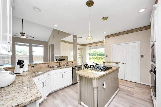 4902 Bellmead Dr, Missouri City, TX 77459 - kitchen with stainless steel appliances, a sink, plenty of natural light, white cabinets, and recessed lighting