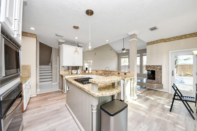 4902 Bellmead Dr, Missouri City, TX 77459 - kitchen with appliances with stainless steel finishes, a sink, light wood-style floors, ceiling fan, and vaulted ceiling
