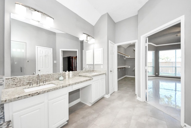 4902 Bellmead Dr, Missouri City, TX 77459 - full bath featuring double vanity, a walk in closet, and tile patterned floors