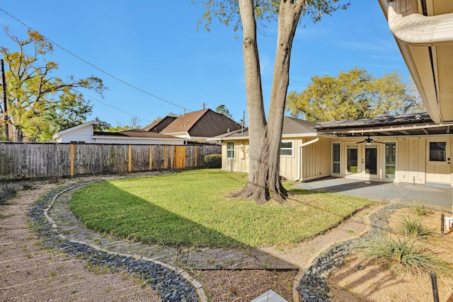 view of yard featuring a ceiling fan, a patio area, a fenced backyard, and french doors