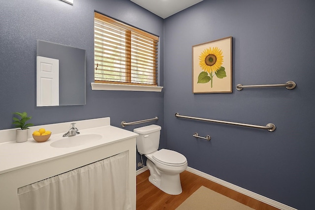 5215 Kingsbury St, Houston, TX 77021 - half bath featuring wood finished floors, toilet, vanity, and baseboards