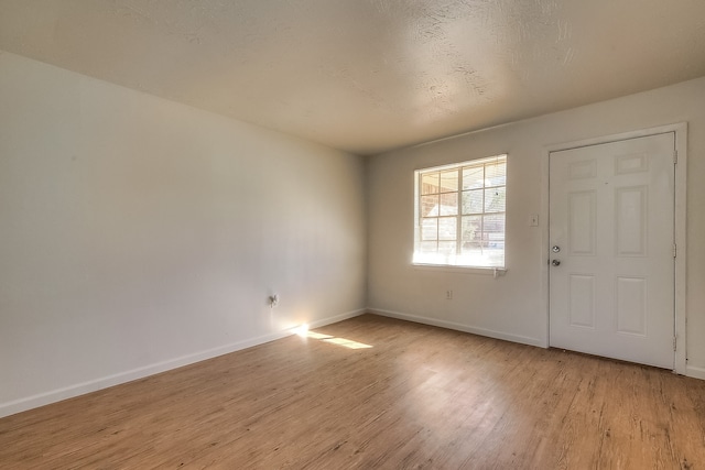 entrance foyer with baseboards and light wood-type flooring